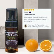 Load image into Gallery viewer, Facial wash for pigmentation and dark spots with orange blossom and lemon essential oil in 100ml bottle next to fresh oranges and customer review