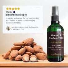 Load image into Gallery viewer, Anti-ageing almond and sunflower oil cleanser bottle with almonds on wooden surface
