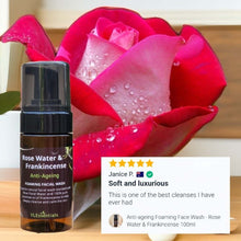 Load image into Gallery viewer, Anti-ageing foaming facial wash with rose water and frankincense in a brown pump bottle next to a red rose and customer review snippet
