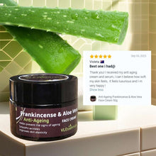 Load image into Gallery viewer, Anti-Ageing Frankincense and Aloe Vera face cream jar with aloe vera leaves and customer review on tiled surface
