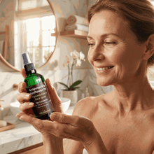 Load image into Gallery viewer, Woman holding VLEssentials Grapeseed &amp; Sunflower Oil Cleanser for pigmentation and dark spots in bathroom
