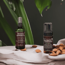 Load image into Gallery viewer, Anti-ageing cleansing bundle with oil cleanser and foaming wash, surrounded by almonds and a natural backdrop.
