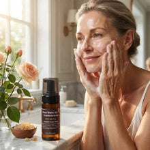 Load image into Gallery viewer, Woman applying VLEssentials Anti-ageing Foaming Face Wash with Rose Water and Frankincense in bright bathroom
