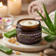 Load image into Gallery viewer, Jar of VLEssentials Frankincense &amp; Aloe Vera Anti-Ageing Face Cream with aloe leaves and natural ingredients on a marble slab
